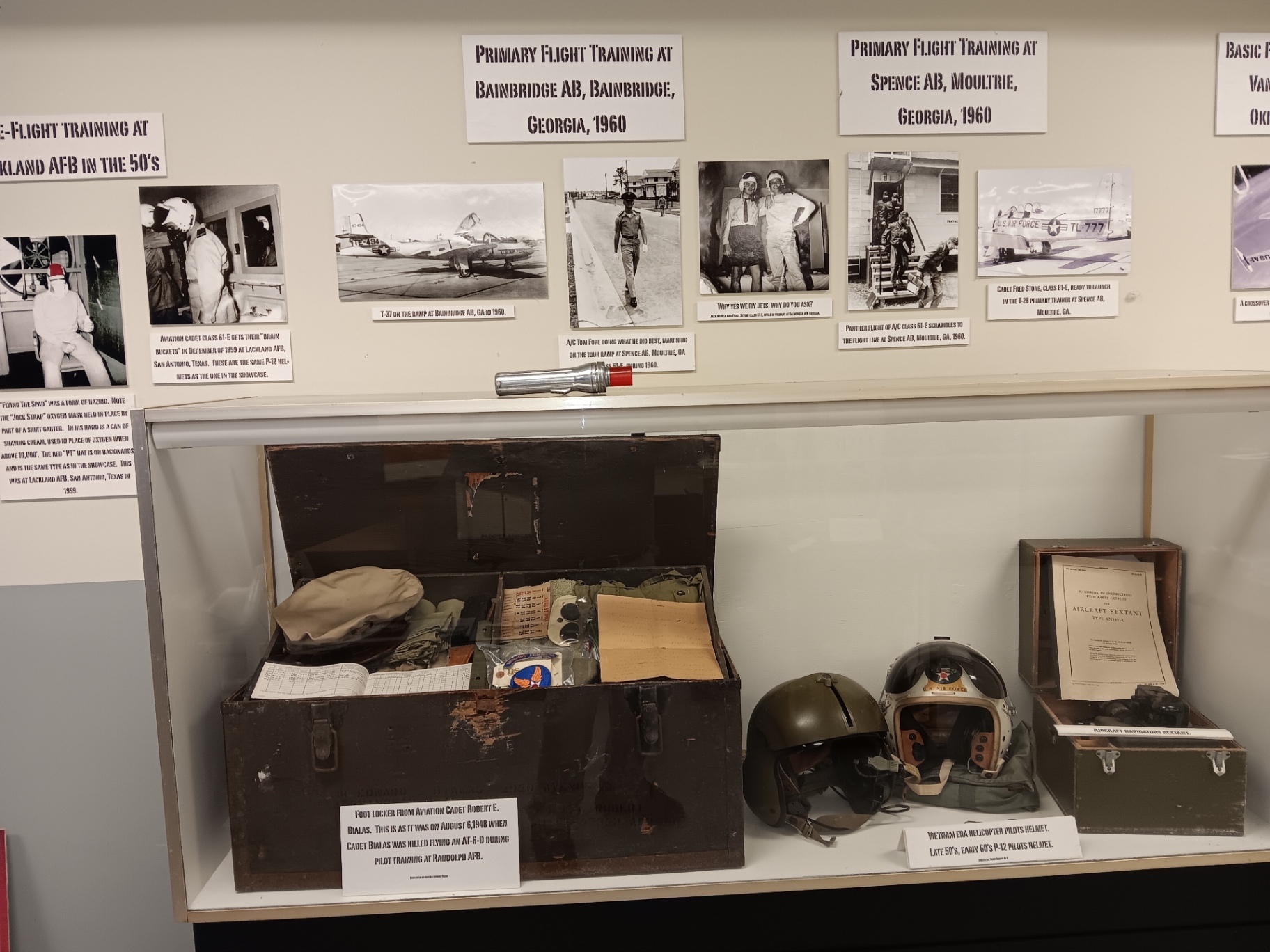 Primary flight training, 1960. The foot locker of Aviation Cadet Robert E. Bialas, left exactly as it was the day he was killed flying an AT-6D, beside a P-12 pilot's helmet.