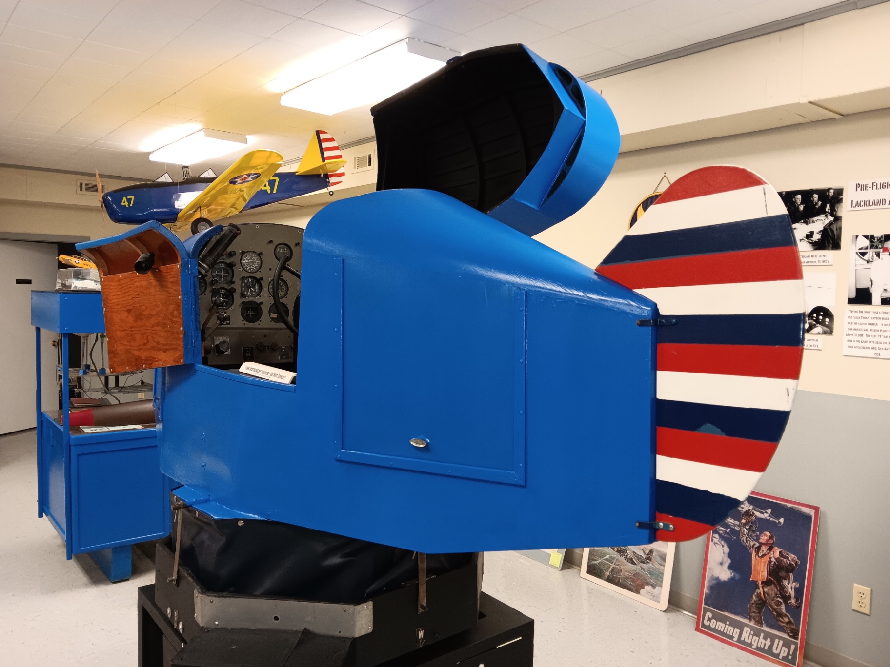 The Link Instrument Trainer itself — the “Blue Box” that taught a generation of cadets to fly on instruments alone, red-white-and-blue tail and all.