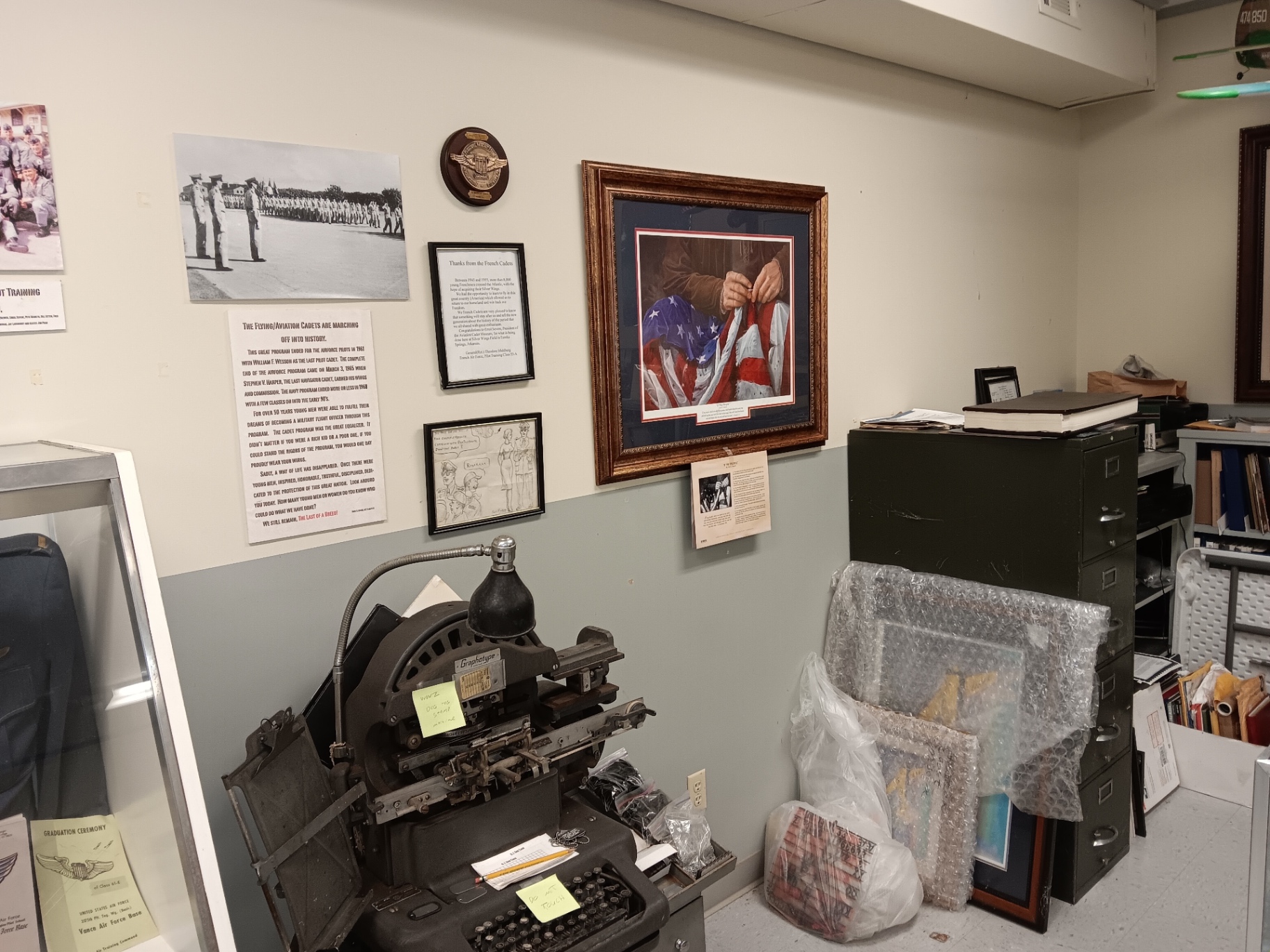 “The Flying/Aviation Cadets are marching off into history.” A letter of thanks from the French cadets who trained here hangs alongside it.