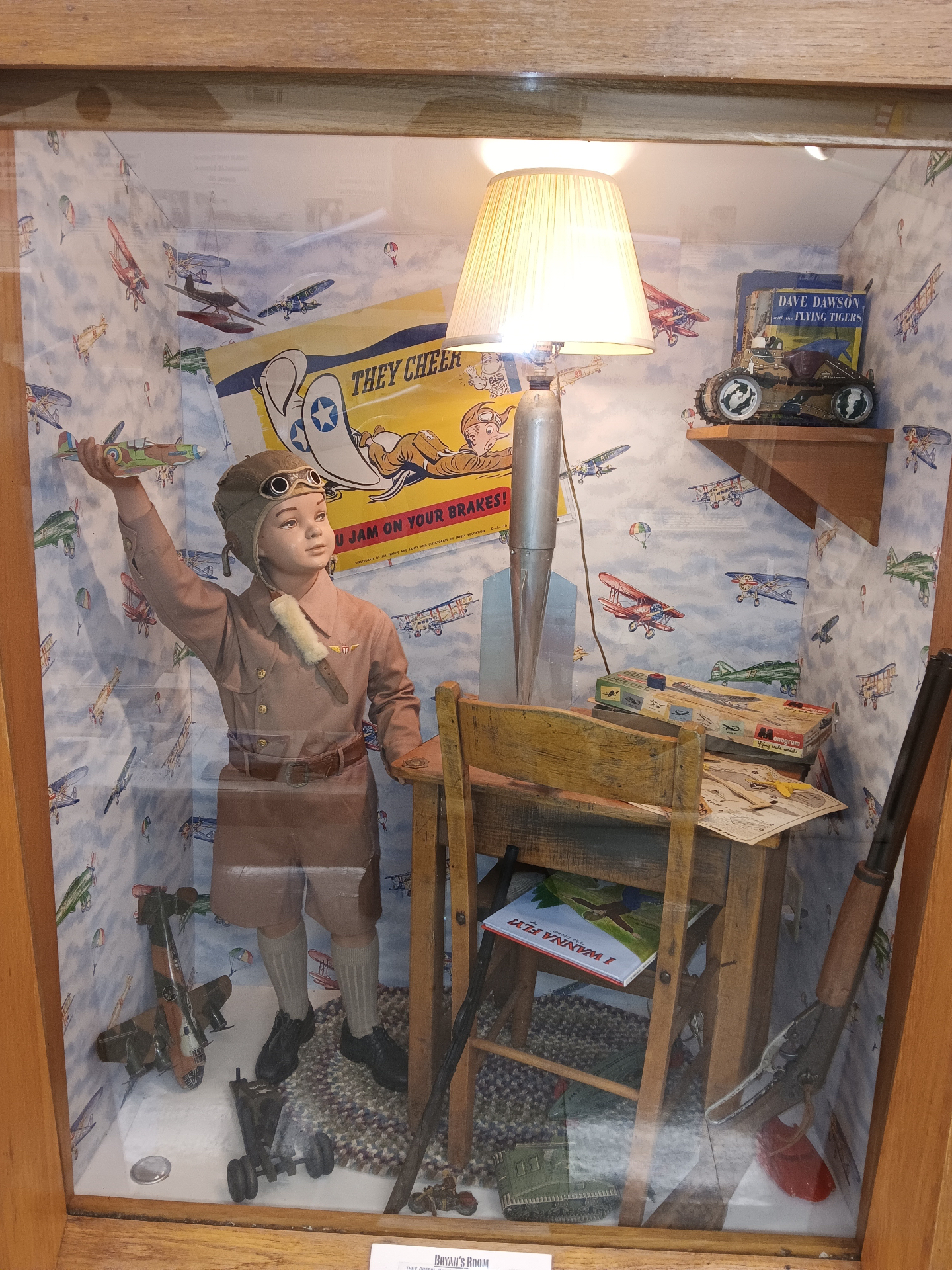 “Bryan's Room” — a 1940s boy's bedroom recreated down to the airplane wallpaper, bomb-casing lamp, school desk, model kits and a “Dave Dawson with the Flying Tigers” novel.